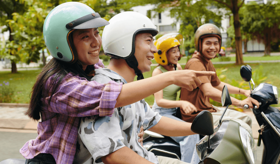 Group of friends laughing on scooters