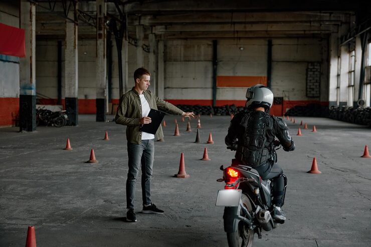 instructor-teaching-young-biker-personal-lesson-motorcycle-school_266732-39305