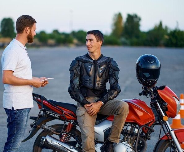 male-student-talking-with-instructor-motordrome-motorcycle-school-training-motorcyclists-beginners-biker-practicing-motorschool_266732-30580 (1)